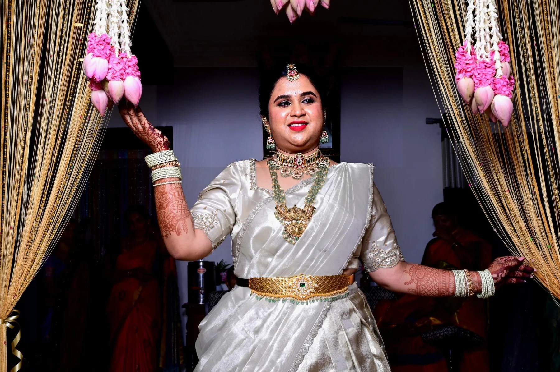 Bride framed by floral entrance decoration